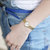 天梭(TISSOT)女表 乐爱系列手表 时尚休闲简约钢带瑞士女士时装表腕表(橙色)第3张高清大图