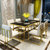银卧后现代新古典简约镀金不锈钢餐桌钢化玻璃6人餐桌椅组合(黑色 两椅)第3张高清大图